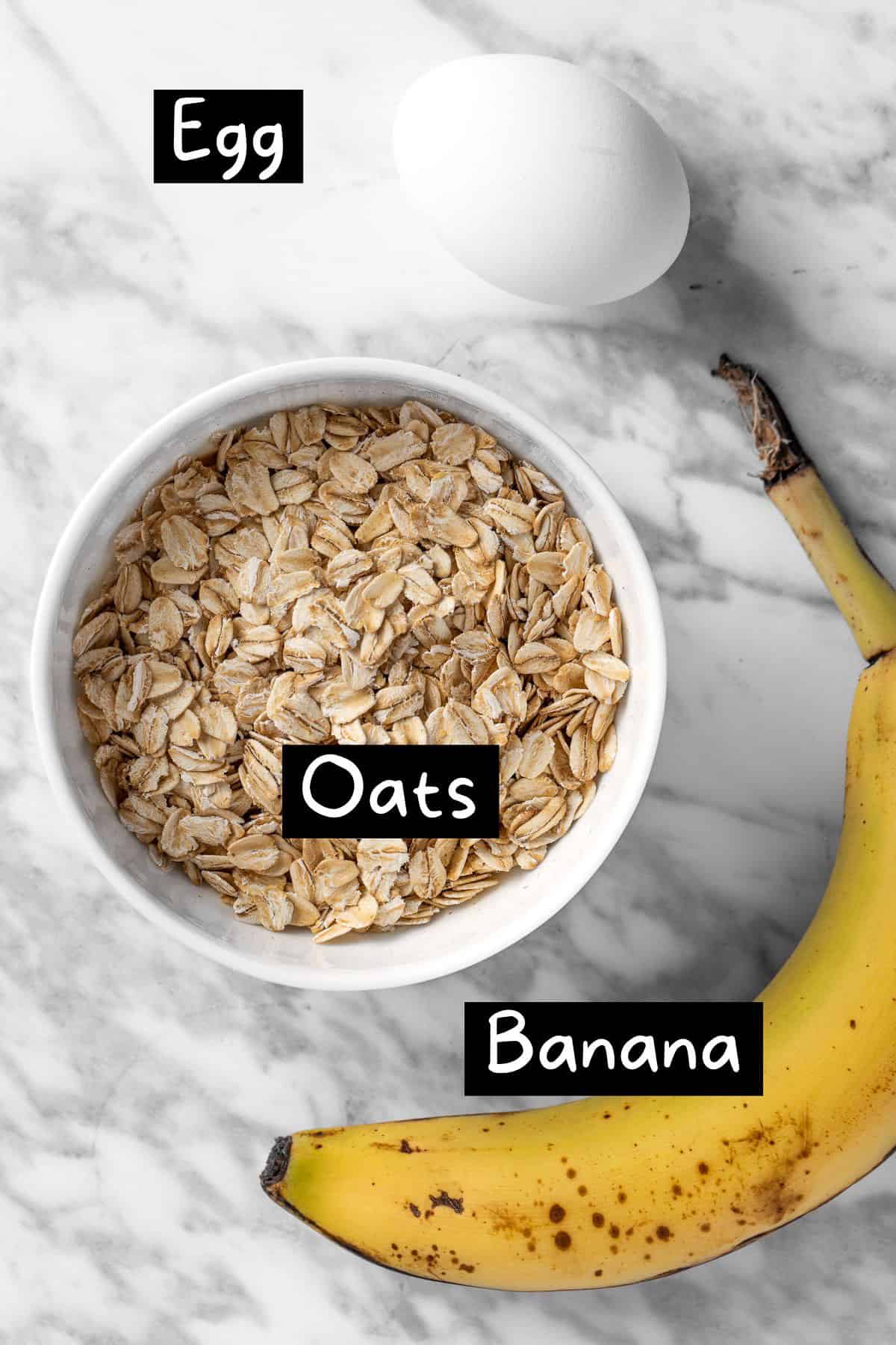 The three ingredients needed to make the pancakes: a banana, egg and oats.