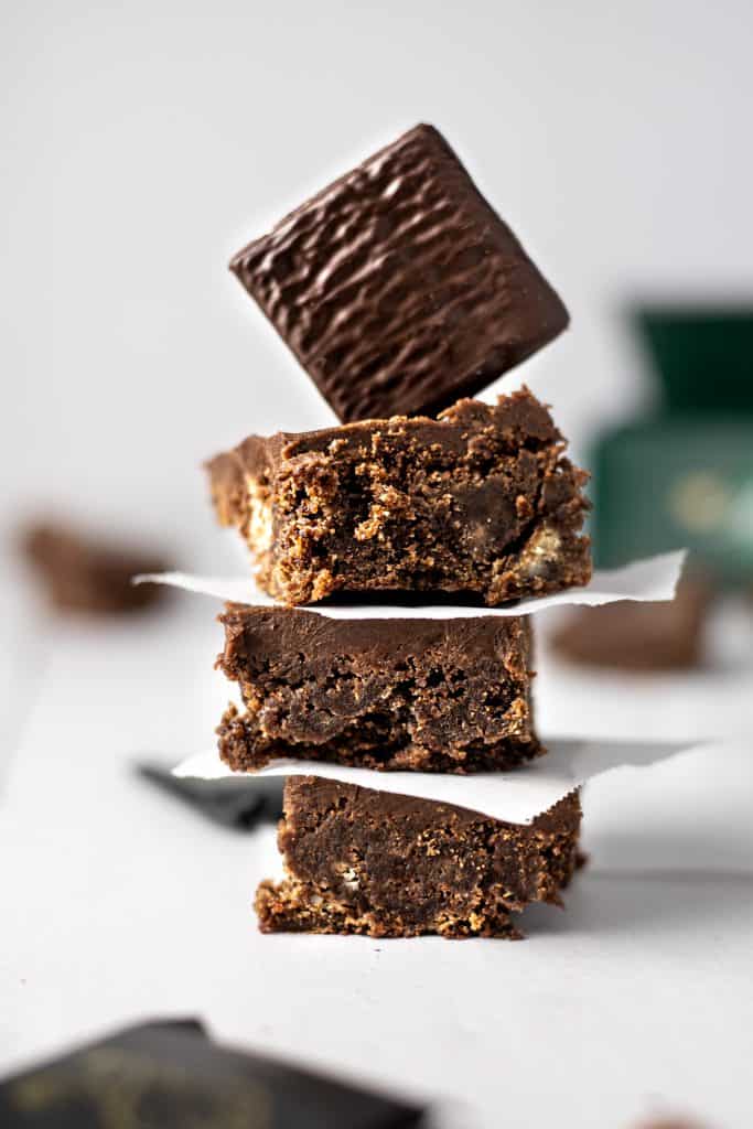 A stack of three after eight brownies with an after eight mint stuck upright on top of the brownie stack