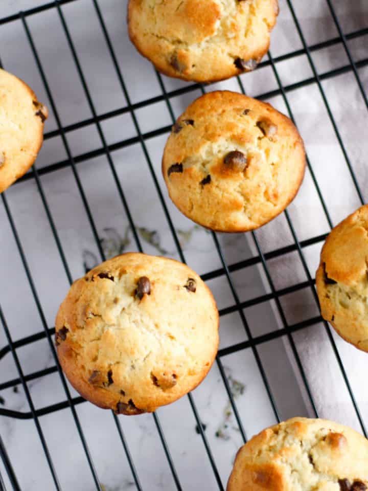 Overhead view of banana ricotta muffins spread out on cooling rack