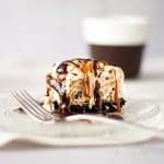 Slice of billy miner pie drenched in caramel and chocolate sauce.