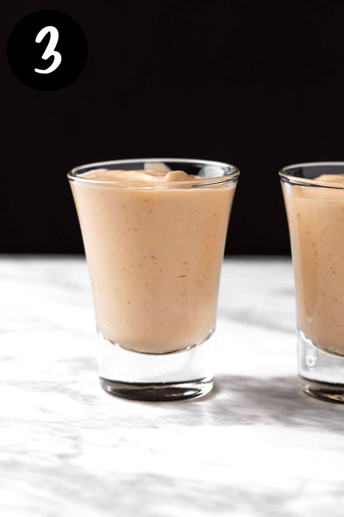 Dividing the butterscotch pudding into shot glasses.