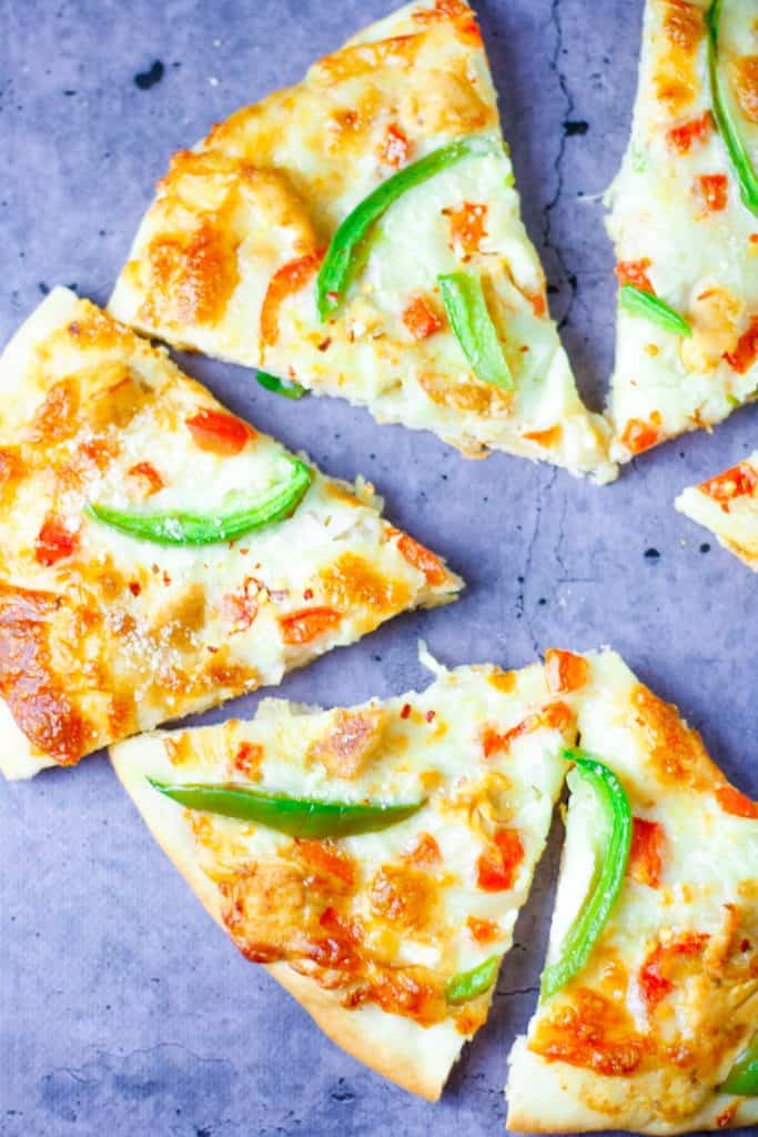 slices of cajun chicken pizza spread out on the table