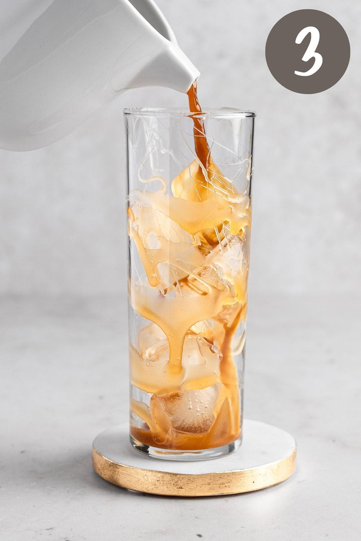 Process photo illustrating the caramel coffee being poured into a glass with ice.