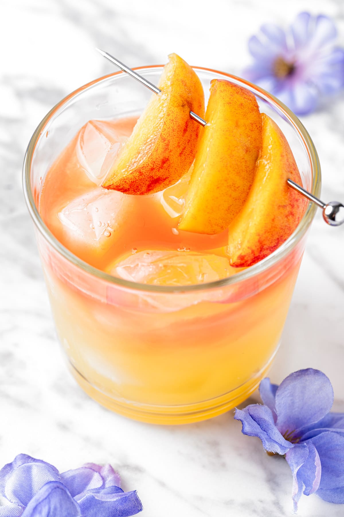 A georgia peach drink garnished with peach slices.