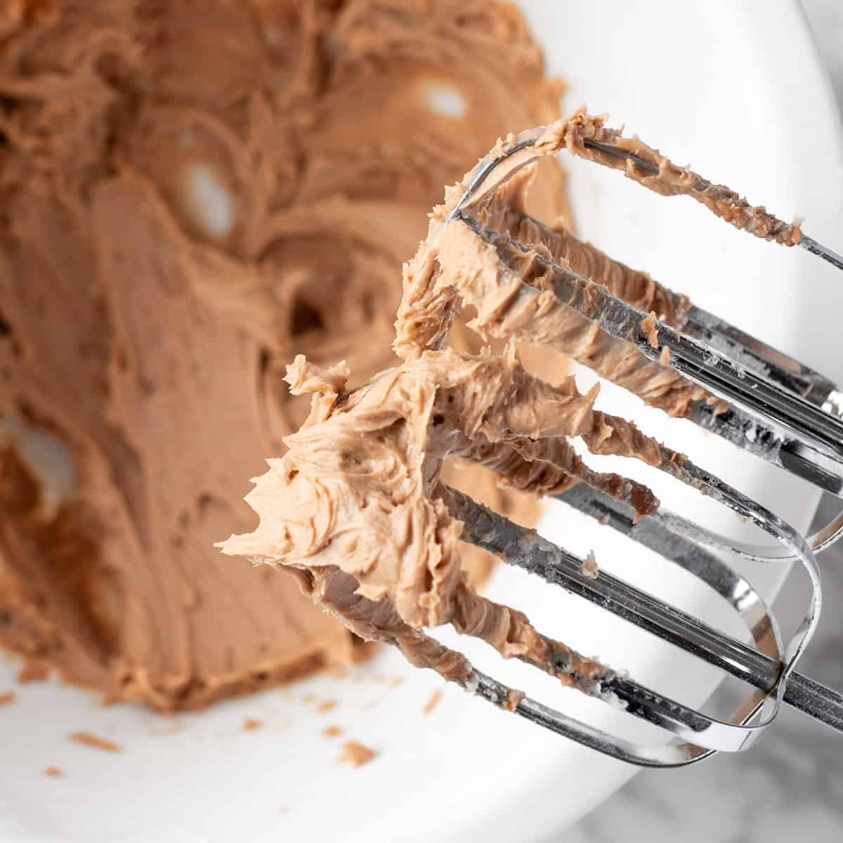 Hazelnut buttercream frosting on an electric mixer. 