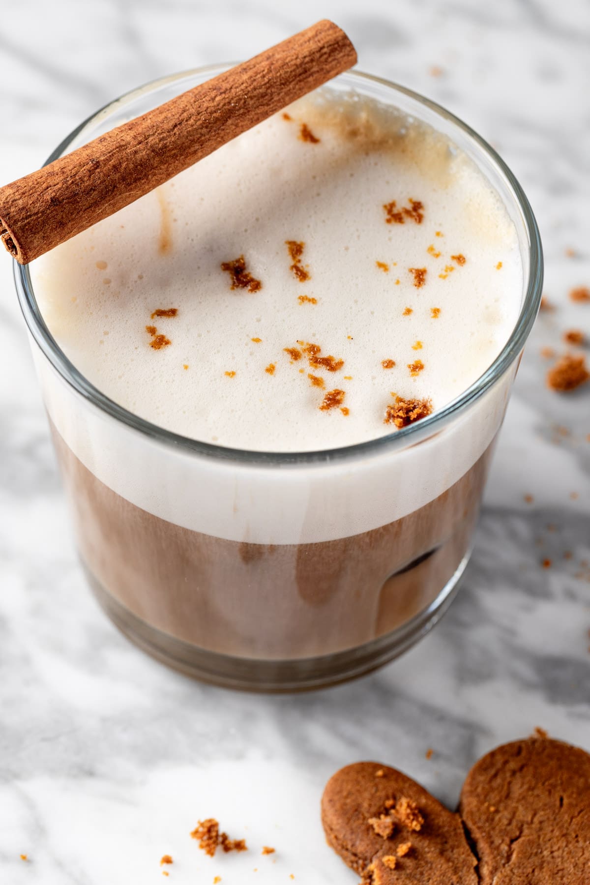 An iced gingerbread latte topped with gingerbread cookie crumbles.