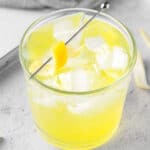 Overhead view of a limoncello tonic garnished with a lemon peel twist.