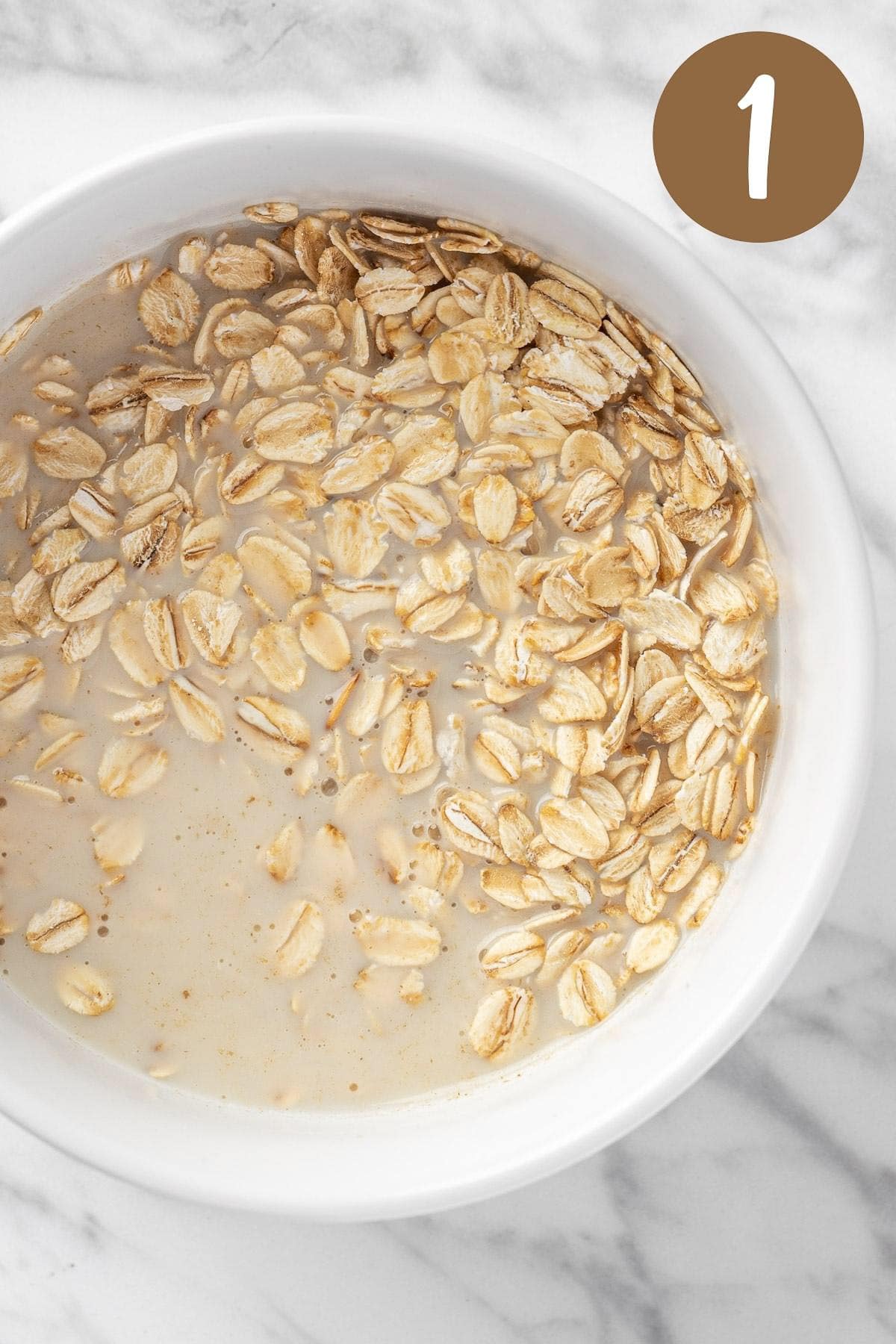 A process photo illustrating step 1: mixing the milk and oats together.