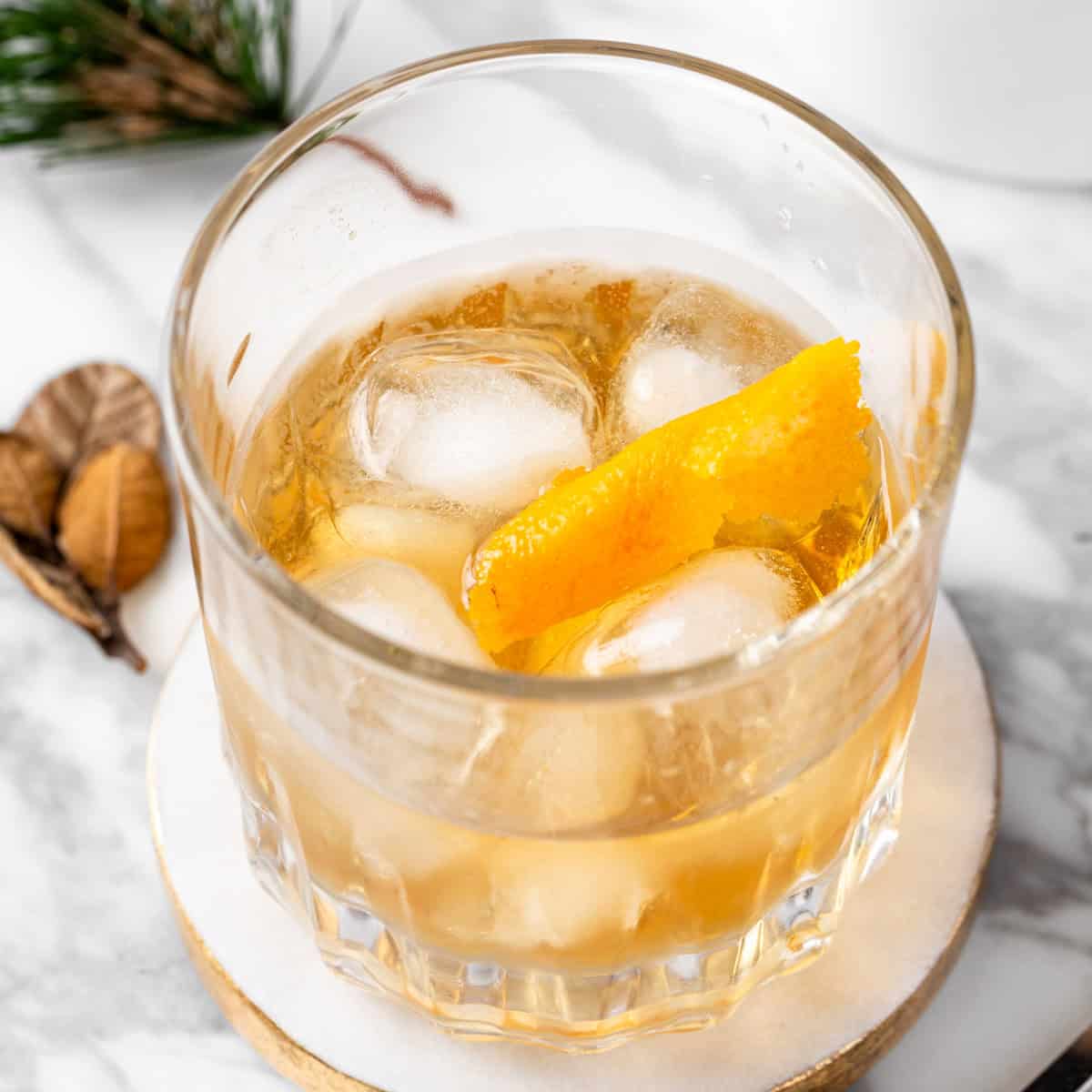 An Old Overholt Cocktail garnished with an orange peel twist.