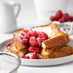 RumChata french toast topped with fresh raspberries and rumchata whipped cream.