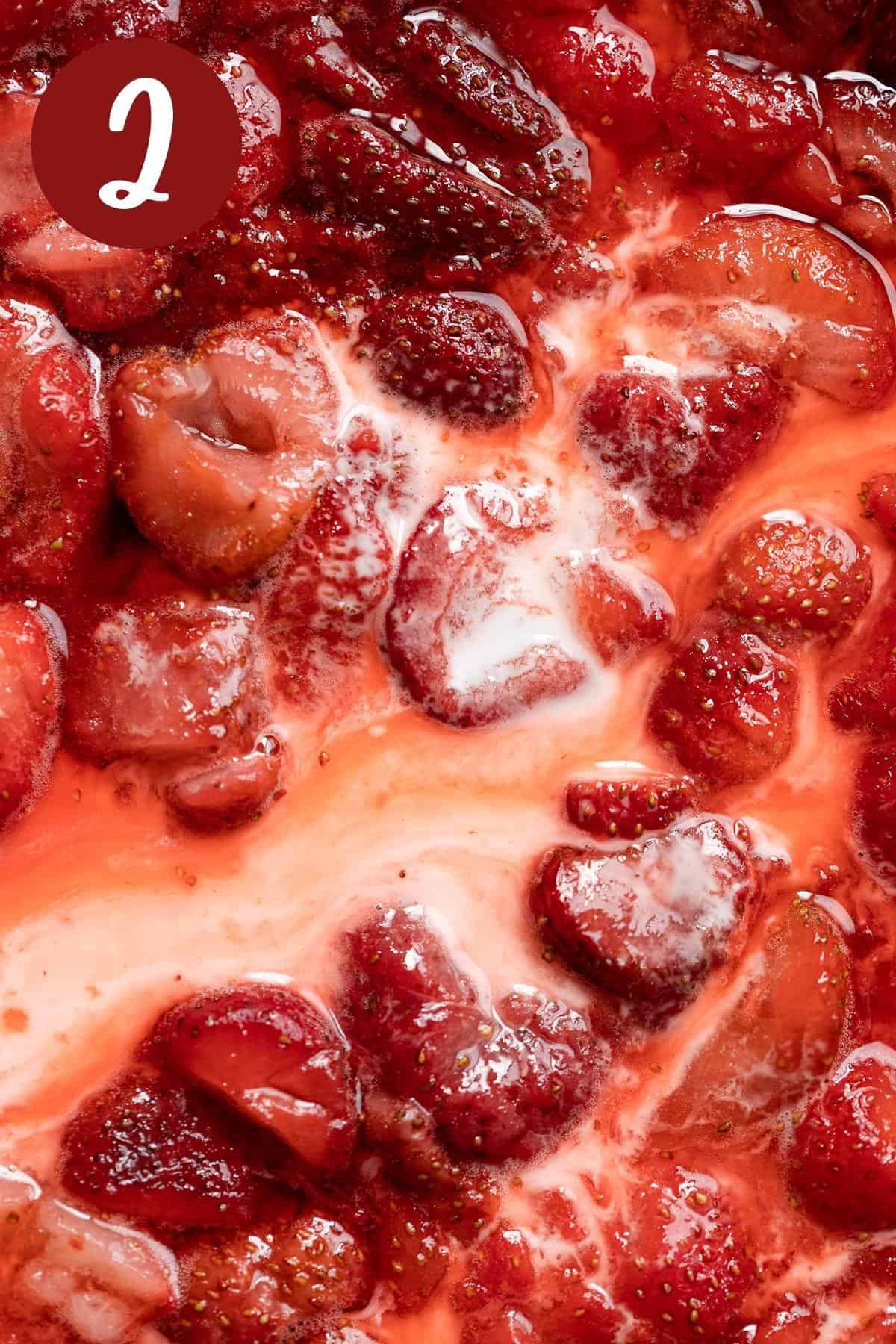 The cornstarch and water mixture mixed in with the strawberry filling, cooking on a pan.