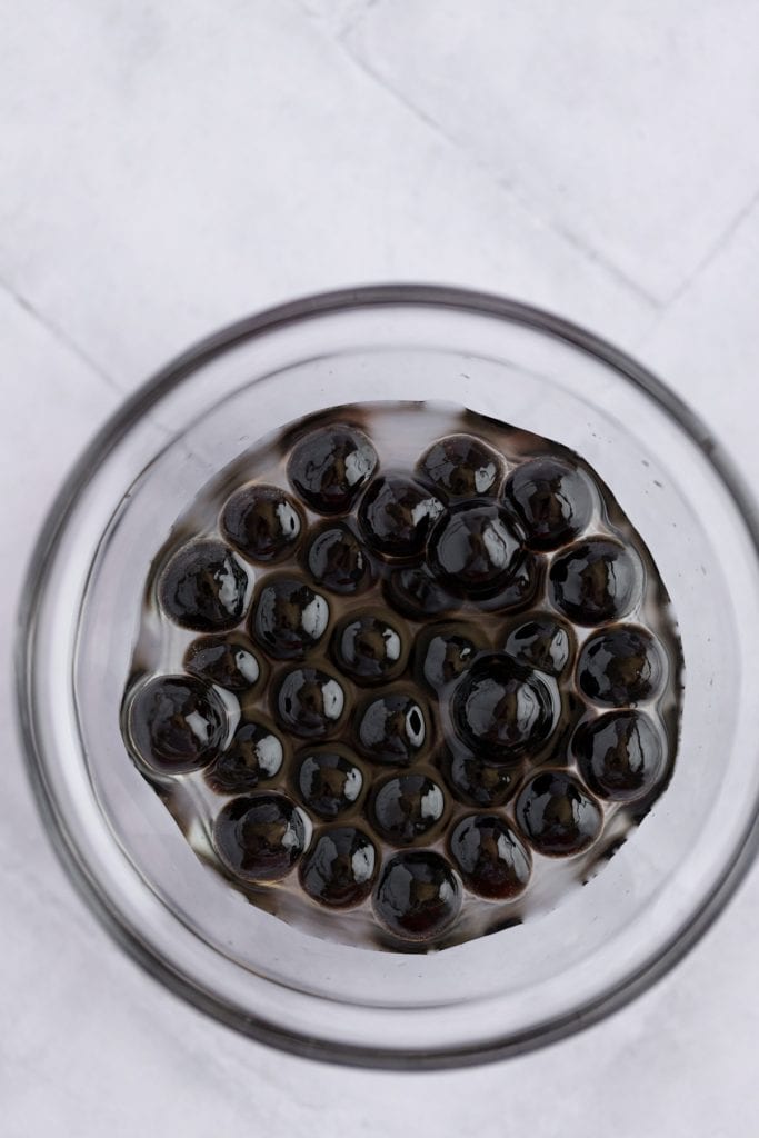 Overhead and up close view of cooked boba in a small glass bowl.