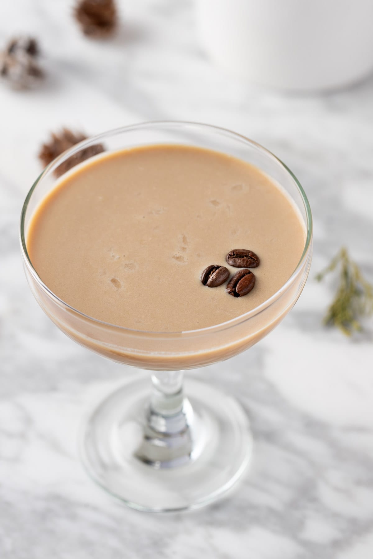 A white chocolate espresso martini on a white marbled table.