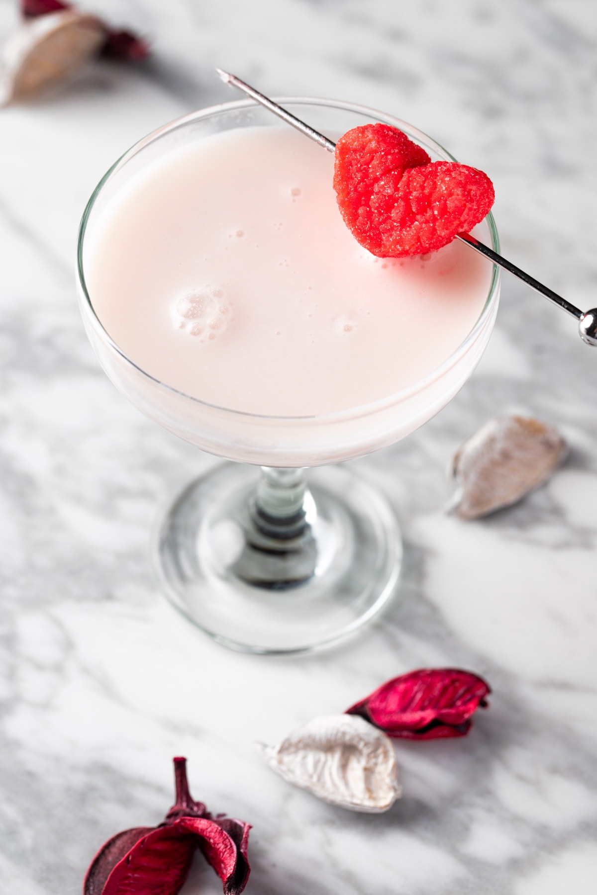 A white chocolate raspberry martini garnished with a heart marshmallow.