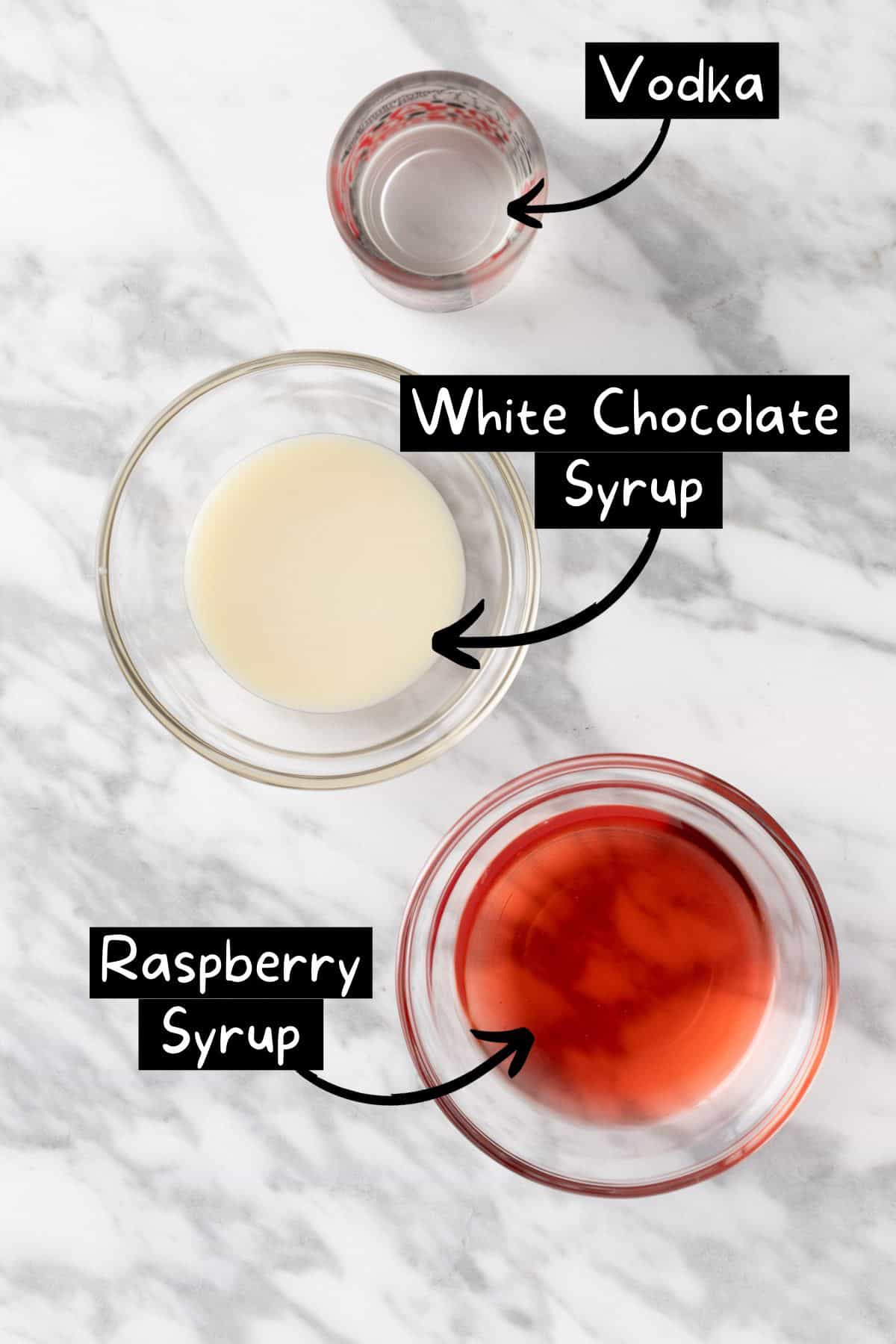 The ingredients needed to make a white chocolate raspberry martini.